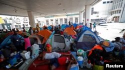 Haitian asylum seekers set up camp in an abandoned gas station while they wait to attempt to cross into the U.S. by an appointment through the Customs and Border Protection app at a makeshift camp, in Matamoros, Mexico, June 21, 2023.