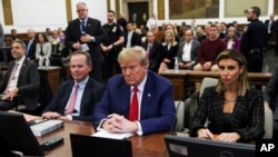 FILE - Former U.S. President Donald Trump, flanked by his lawyers, attends the closing arguments in the Trump Organization civil fraud trial at New York State Supreme Court in the Manhattan borough of New York, Jan. 11, 2024.