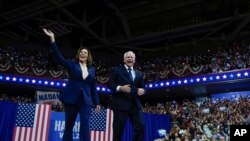 Democratic presidential nominee Vice President Kamala Harris and her running mate Minnesota Gov. Tim Walz arrive at a campaign rally in Philadelphia, Aug. 6, 2024.