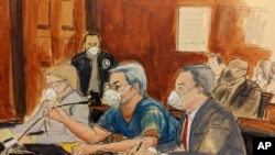 In this courtroom sketch, former Honduran President Juan Orlando Hernández, center, speaks into a microphone while pleading not guilty to drug trafficking and weapons charges, May 10, 2022, in New York.