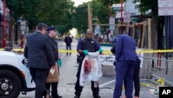 Philadelphia Police investigators work the scene of a fatal overnight shooting on South Street in Philadelphia, Pennsylvania, June 5, 2022.