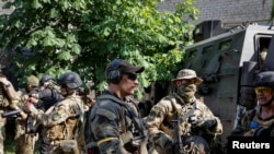 Members of foreign volunteers unit which fights in the Ukrainian army stand next to a vehicle in Sievierodonetsk, Luhansk region Ukraine June 2, 2022.