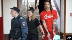 WNBA star and two-time Olympic gold medalist Brittney Griner is escorted to a courtroom for a hearing, in Khimki just outside Moscow,