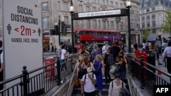 Người dân Anh mang khẩu trang đi vào trạm xe điện ngầm Oxford Circus London tại trung tâm London, ngày 7/6/2021. 