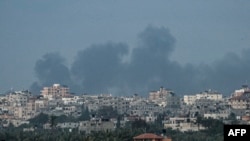 TOPSHOT - Smoke billows following Israeli bombardment north of Nuseirat in the central Gaza Strip on April 27, 2024, amid the ongoing conflict in the Palestinian territory between Israel and the militant group Hamas.