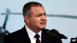 FILE - Mexico's Genaro Garcia Luna speaks during a ceremony to designate June 2 as Federal Police Day in Mexico City, June 2, 2011. 