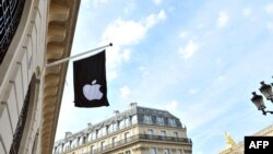 (FILES) An Apple Logo banner hangs from the facade of an Apple store near The Opera Garnier in Paris on July 1, 2010, ahead of its opening in the French capital.