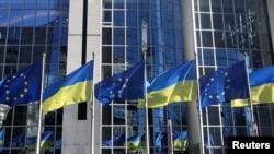 FILE PHOTO: Flags of European Union and Ukraine flutter outside EU Parliament building, in Brussels