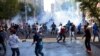 FILE - In this Oct. 7, 2014, photo, Turkish riot police use water cannons and tear gas to disperse people protesting against Turkey's policy in Syria, in Diyarbakir, Turkey. 