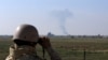 In this Tuesday, Nov. 13, 2018 photo, an Iraqi soldier watches smoke rising after an airstrike by US-led International coalition warplanes against ISIS, on the border between Syria and Iraq in Qaim, Anbar province, Iraq. More than a year after this…