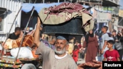 Displaced Palestinians make their way as they flee the eastern part of Khan Younis