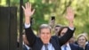 Venezuelan opposition leader Edmundo Gonzalez Urrutia (Front) waves to supporters next to Uruguay's President Luis Lacalle Pou after a meeting at the Suarez and Reyes presidential residence in Montevideo on January 4, 2025.