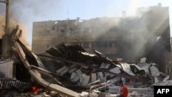 TOPSHOT - A Palestinian boy sits on the rubble of the destroyed Maghazi Camp Services Club building following an Israeli strike on the Maghazi refugee camp in the Gaza Strip on October 24, 2024, amid the ongoing war between Israel and Hamas.