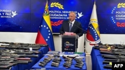 This handout picture released by Venezuela´s Interior and Justice Ministry shows Venezuela’s Interior Minister Diosdado Cabello giving a press conference next to seized weapons on display in Caracas on September 14, 2024.