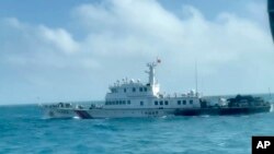 In this screen grab from video released by the Taiwan Coast Guard, a view of a China Coast Guard boat from a Taiwan Coast Guard boat as it passes near the coast of Matsu islands, Taiwan on Oct. 14, 2024. 