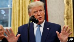 President Donald Trump speaks during a ceremony in the Oval Office of the White House, Oct. 8, 2019.