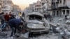 A man inspects a destroyed vehicle amidst debris and rubble at the site of Israeli bombardment on a residential block in Jalaa Street in Gaza City on January 14, 2025 amid the ongoing war in the Palestinian territory between Israel and Hamas.