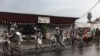 Members of the M23 armed group walk alongside residents through a street of the Keshero neighborhood in Goma, on January 27, 2025.