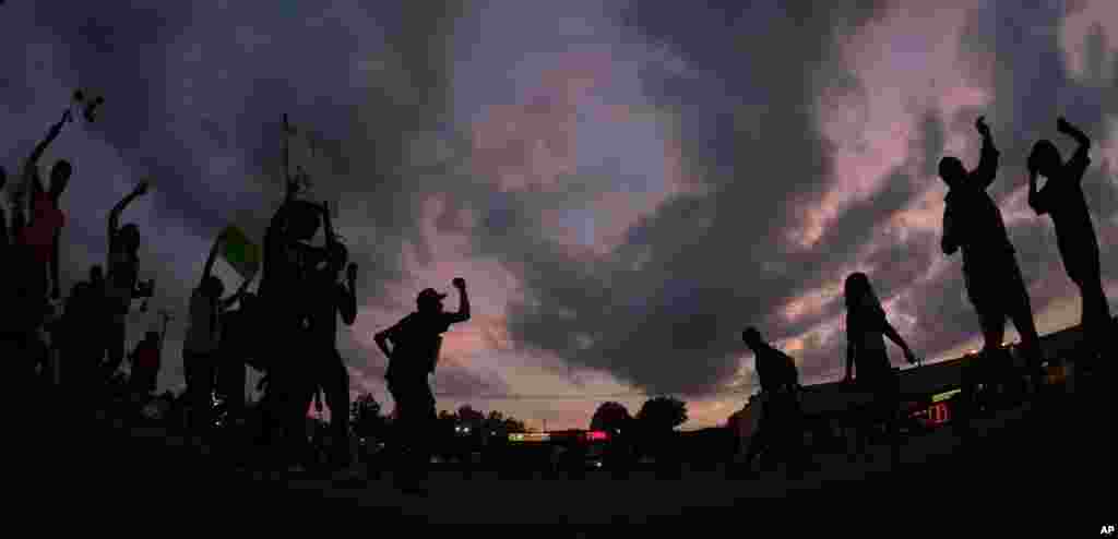 Demonstrators protest the shooting death of Michael Brown in Ferguson, Missouri, Aug. 18, 2014.