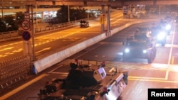 Military vehicles of the Chinese People's Liberation Army (PLA) pass Huanggang Port for a routine troop rotation in Hong Kong, August 29, 2019.