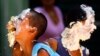 Children react with their faces covered in cream from a 450-metre long cake that was prepared as part of celebrations to mark the 450th anniversary of the city of Rio de Janeiro March 1, 2015. REUTERS/Ricardo Moraes (BRAZIL - Tags: SOCIETY ANNIVERSARY FOO