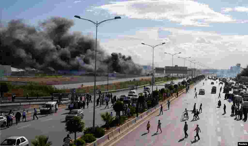 Protesters set fire to trees in the U.S. Embassy compound in Tunis September 14, 2012.&nbsp;