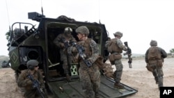 FILE - U.S. soldiers land with an amphibious assault vehicle on the beachhead during U.S.-Thai "Cobra Gold" joint military exercises on Hat Yao beach in Chonburi province, eastern Thailand, Feb. 28, 2020.