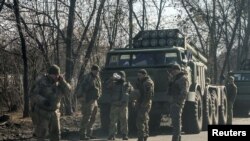 Ukrainian army soldiers stand next to multiple launch missile systems, after Russian President Vladimir Putin authorised a military operation, in eastern Ukraine, in Kharkiv region, Ukraine February 24, 2022.