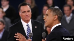 U.S. President Barack Obama (R) speaks as Republican presidential nominee Mitt Romney (L) listens during the second U.S. presidential debate in Hempstead, New York, October 16, 2012. 