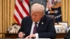 US President Donald Trump signs an executive order regarding Department of Government Efficiency (DOGE), in the Oval Office of the WHite House in Washington, DC, on January 20, 2025. (Photo by Jim WATSON / POOL / AFP)