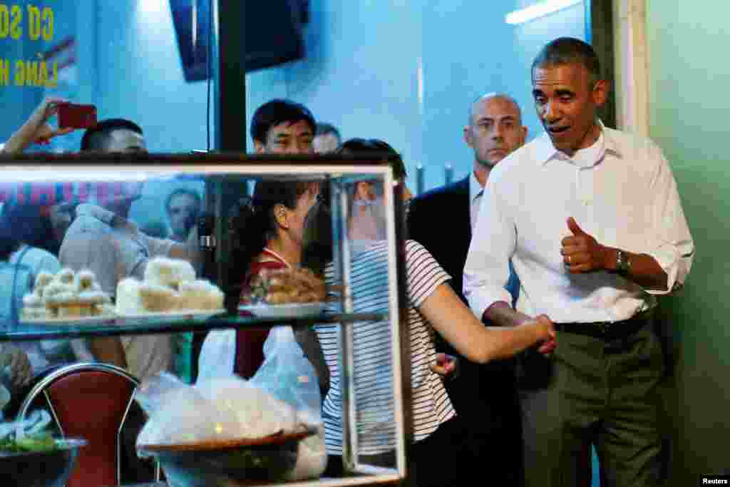 Tổng thống Obama bắt tay chủ quán bún chả Hà Nội sau khi ăn tối với đầu bếp Anthony Bourdain.