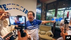 FILE - Nicaraguan journalist Miguel Mora speaks to the press after his release from prison, at his home in Managua, June 11, 2019.