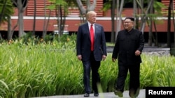 Tổng thống Mỹ Donald Trump (trái) và lãnh tụ Bắc Hàn Kim Jong Un tại Singapore trước cuộc gặp thượng đỉnh hôm 12/6.